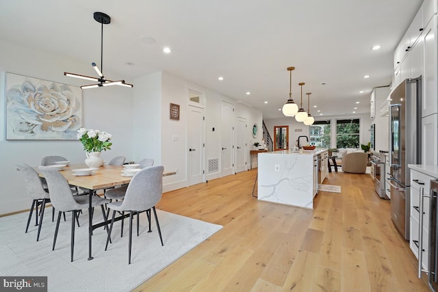 dining space featuring sink and light hardwood / wood-style floors