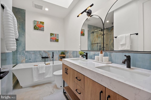 full bathroom featuring vanity, plus walk in shower, tile walls, and toilet