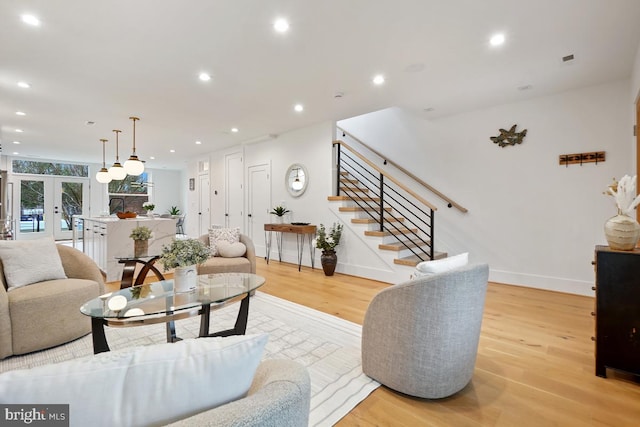 living room with french doors and light wood-type flooring