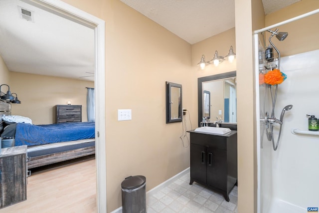 bathroom featuring a textured ceiling and vanity