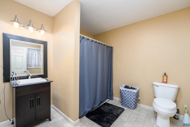 bathroom with vanity, a shower with shower curtain, and toilet