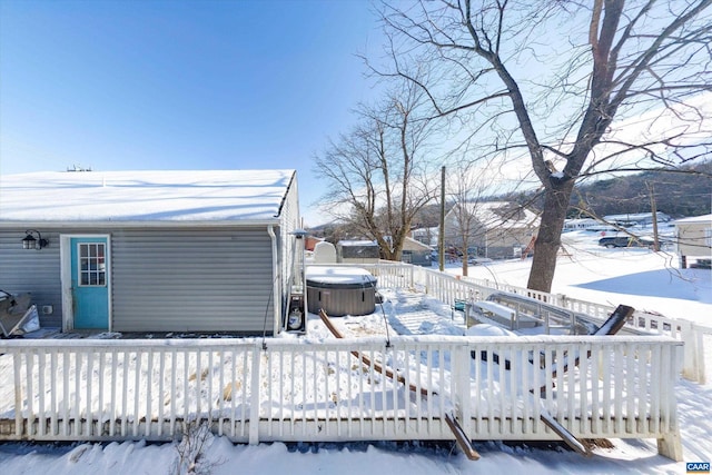 snow covered deck featuring a hot tub