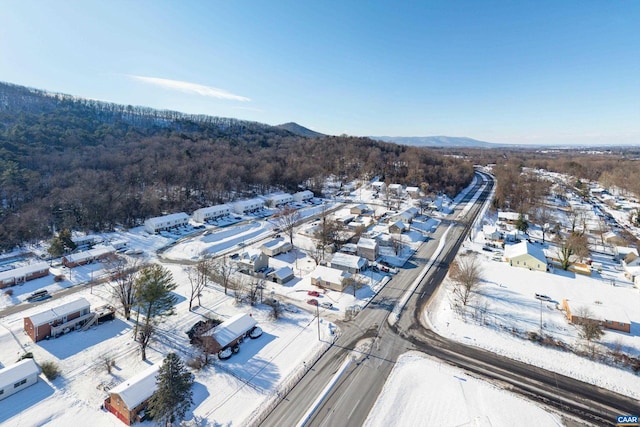 snowy aerial view with a mountain view