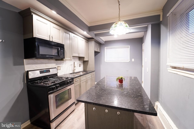 kitchen with stainless steel gas range oven, white cabinets, crown molding, sink, and tasteful backsplash