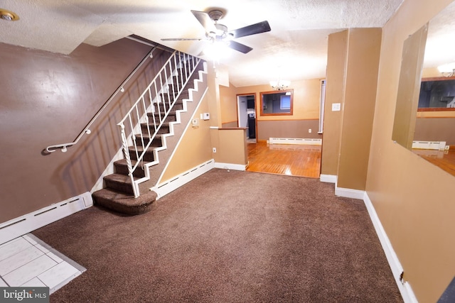 staircase with carpet flooring, ceiling fan with notable chandelier, and a baseboard radiator