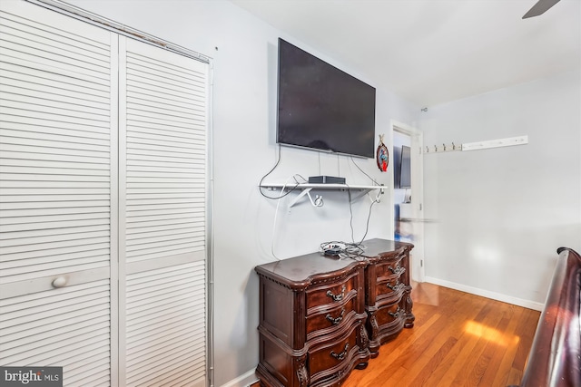 bedroom with ceiling fan, hardwood / wood-style floors, and a closet