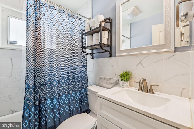 bathroom featuring toilet, tile walls, decorative backsplash, and vanity