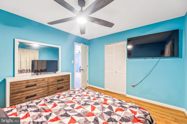 bedroom with ceiling fan, hardwood / wood-style floors, and a closet