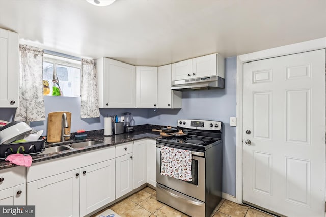 kitchen featuring sink, electric stove, light tile patterned floors, and white cabinetry