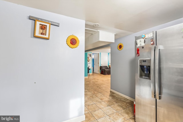 kitchen with light tile patterned flooring and stainless steel fridge with ice dispenser