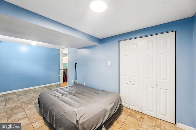 tiled bedroom featuring a closet