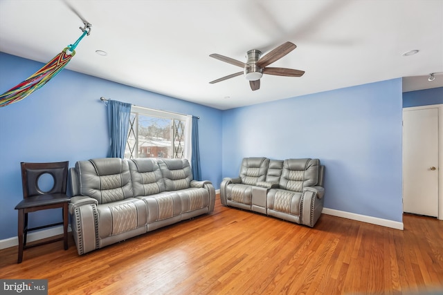 living room with ceiling fan and light wood-type flooring