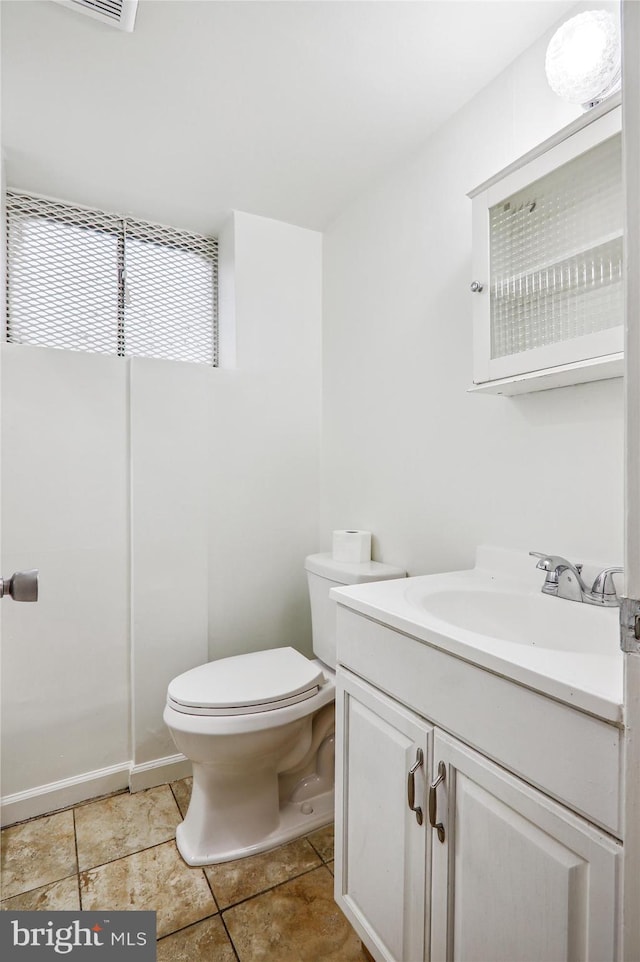 bathroom with tile patterned flooring, vanity, and toilet