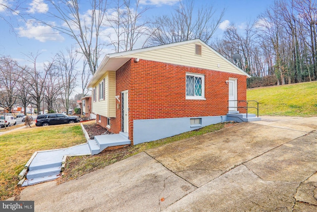 view of side of property with a lawn