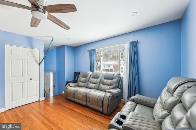 living room with ceiling fan and light wood-type flooring