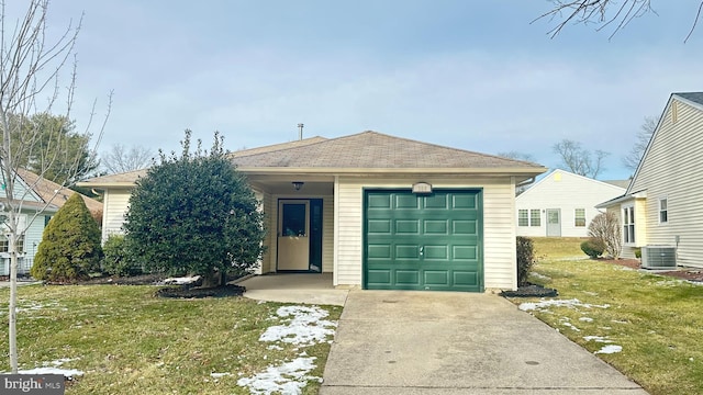 view of front of house with a garage, a front lawn, and central air condition unit