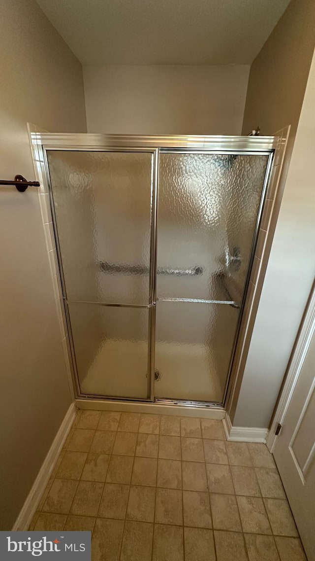 bathroom with a shower with shower door