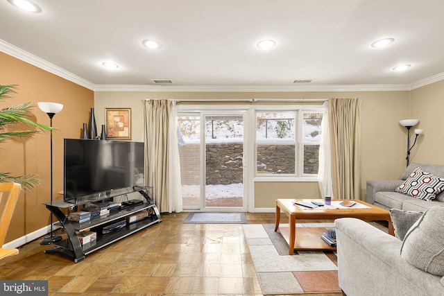 living room with crown molding, a wealth of natural light, and light parquet flooring