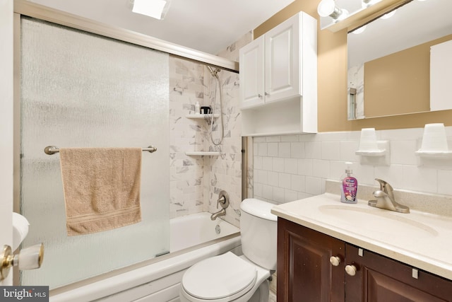 full bathroom with backsplash, bath / shower combo with glass door, vanity, tile walls, and toilet