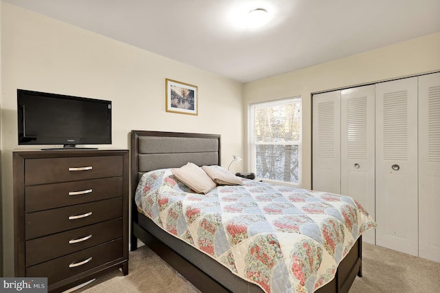 bedroom featuring light carpet and a closet