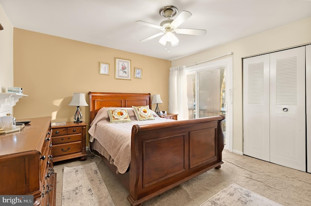 carpeted bedroom with a closet and ceiling fan