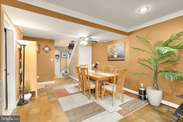 dining area with crown molding, light parquet flooring, and ceiling fan