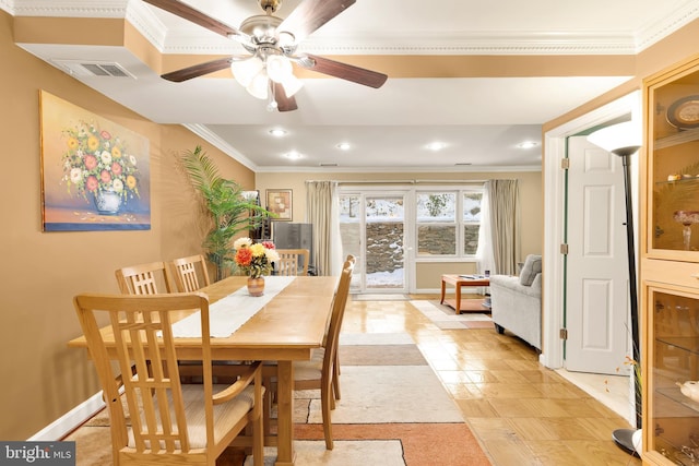 dining space featuring ceiling fan and ornamental molding