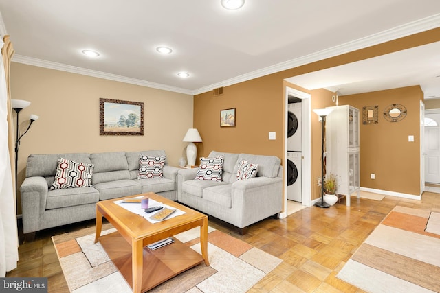 living room featuring parquet flooring, stacked washing maching and dryer, and ornamental molding