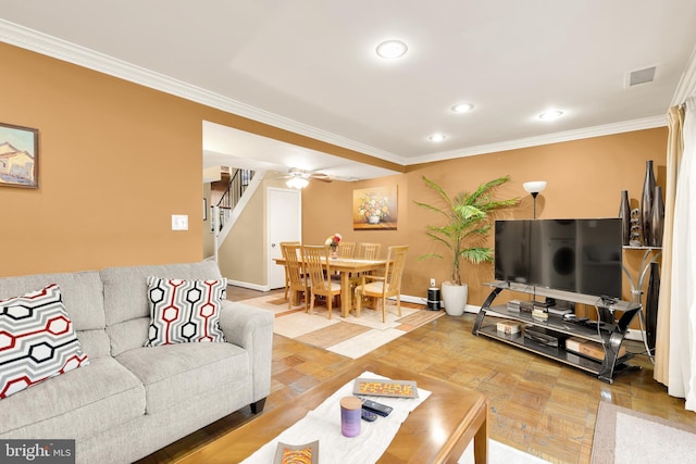 living room featuring crown molding, parquet floors, and ceiling fan