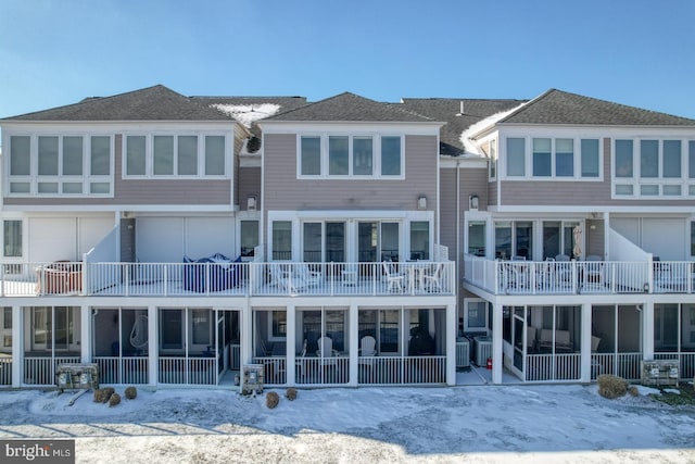 snow covered property featuring central AC