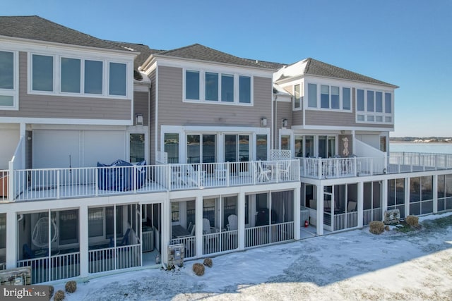 view of snow covered rear of property