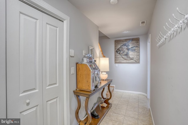 corridor with light tile patterned floors