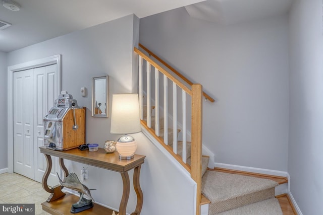 stairway featuring tile patterned flooring