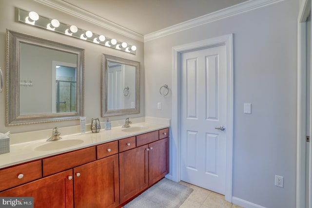 bathroom with vanity, ornamental molding, and tile patterned flooring