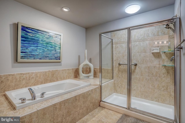 bathroom featuring tile patterned floors and shower with separate bathtub