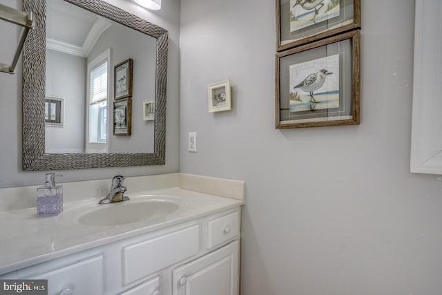 bathroom with vanity, ornamental molding, and lofted ceiling