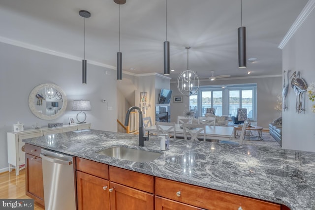 kitchen with sink, dishwasher, stone counters, and pendant lighting