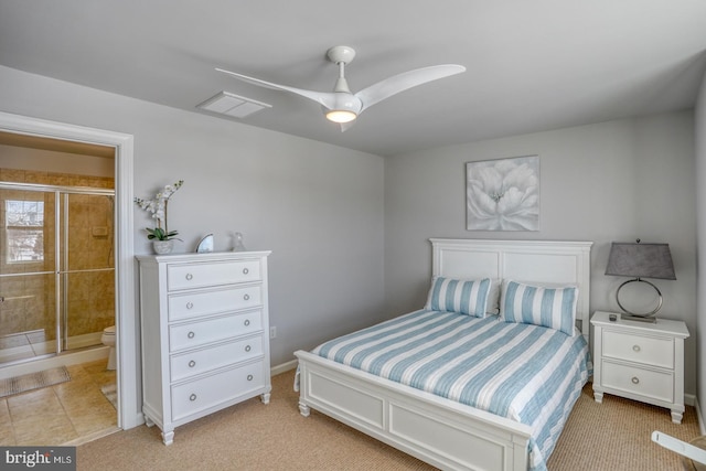 carpeted bedroom with ceiling fan and ensuite bathroom