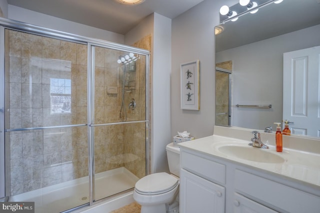 bathroom featuring vanity, toilet, and walk in shower