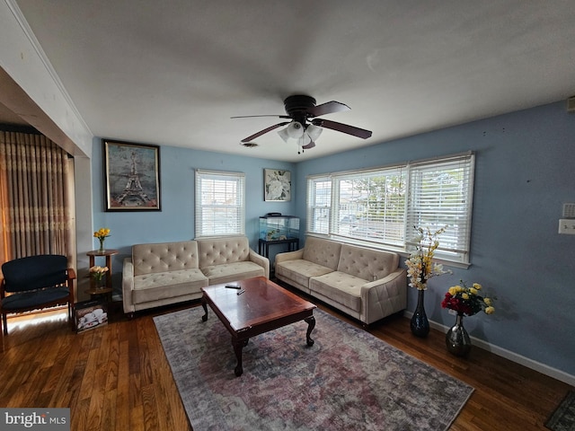 living area with dark wood-style floors, a ceiling fan, and baseboards