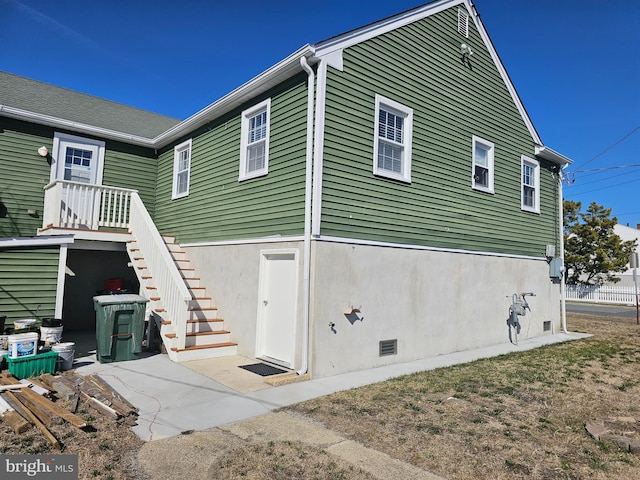 exterior space with stucco siding and stairs