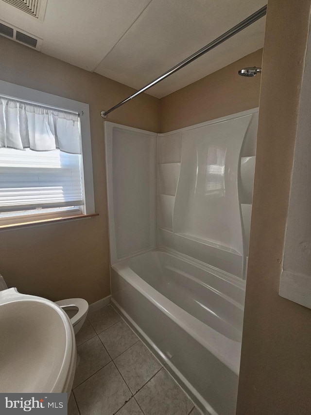 bathroom featuring bathtub / shower combination, visible vents, toilet, baseboards, and tile patterned floors