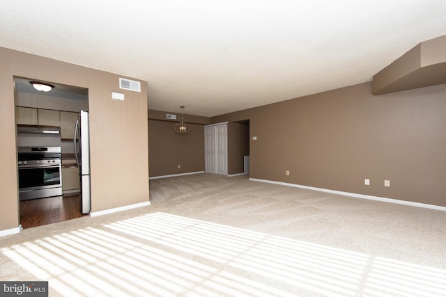 unfurnished living room featuring carpet flooring