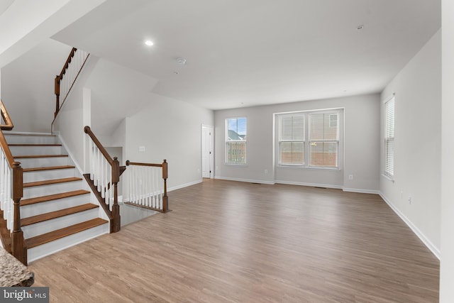 unfurnished living room with hardwood / wood-style floors