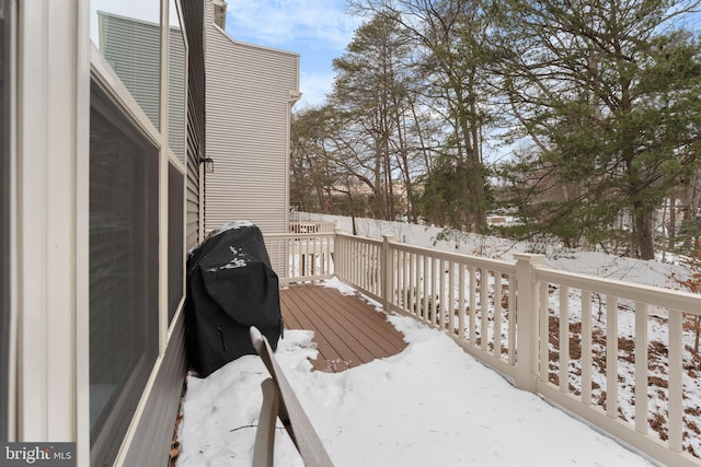 snow covered deck featuring area for grilling