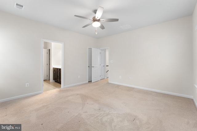 unfurnished bedroom featuring ceiling fan, connected bathroom, and light colored carpet