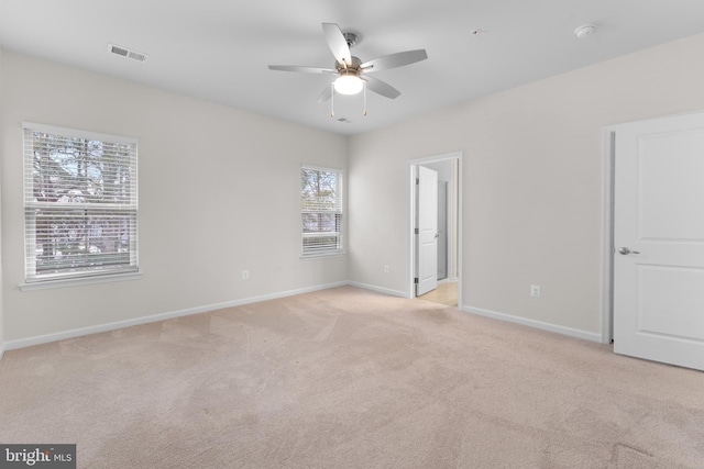 empty room featuring light carpet and ceiling fan