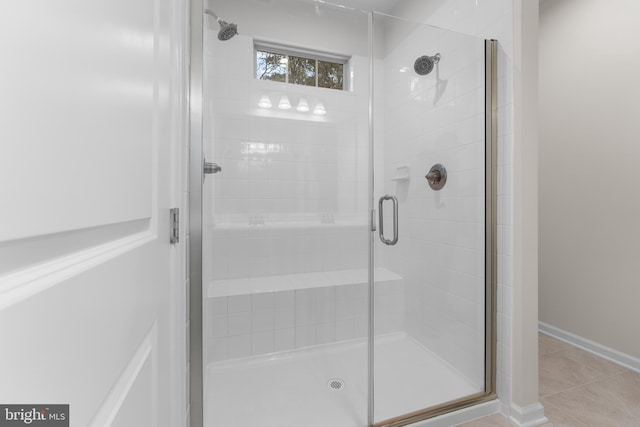 bathroom with tile patterned floors and an enclosed shower