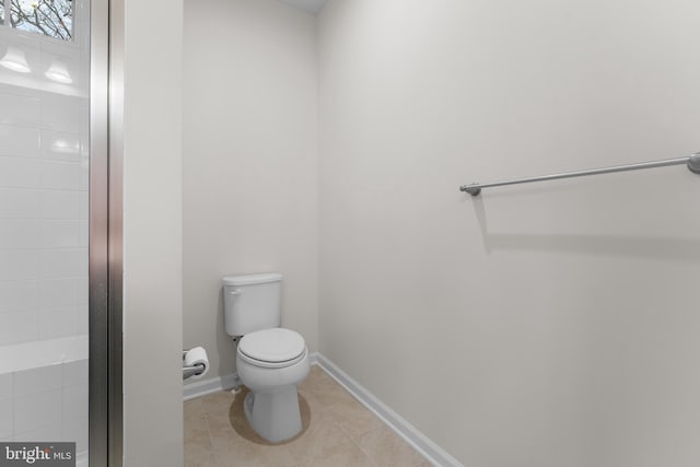 bathroom featuring toilet and tile patterned flooring