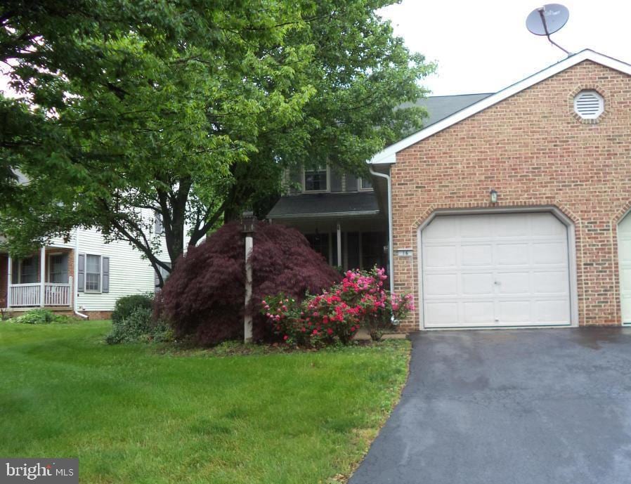 view of front of home with a garage and a front yard